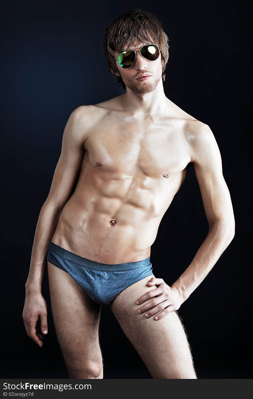 Portrait of a handsome muscular young man. Shot in a studio. Portrait of a handsome muscular young man. Shot in a studio.