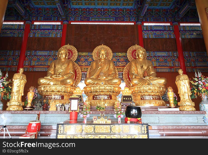 Three big golden buddha in chinese temple. In Thailand.