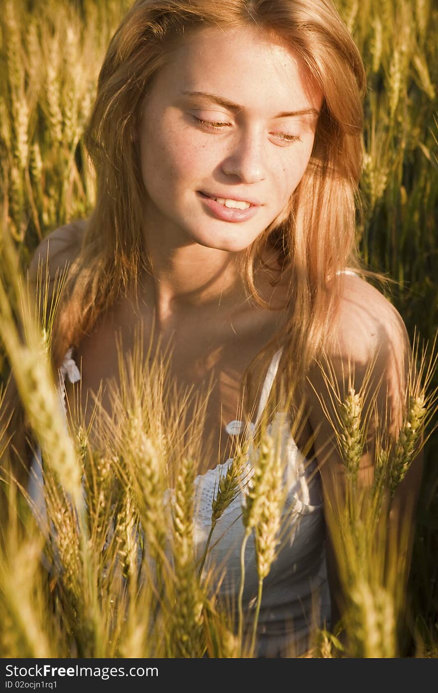 A beautiful woman walks across the field