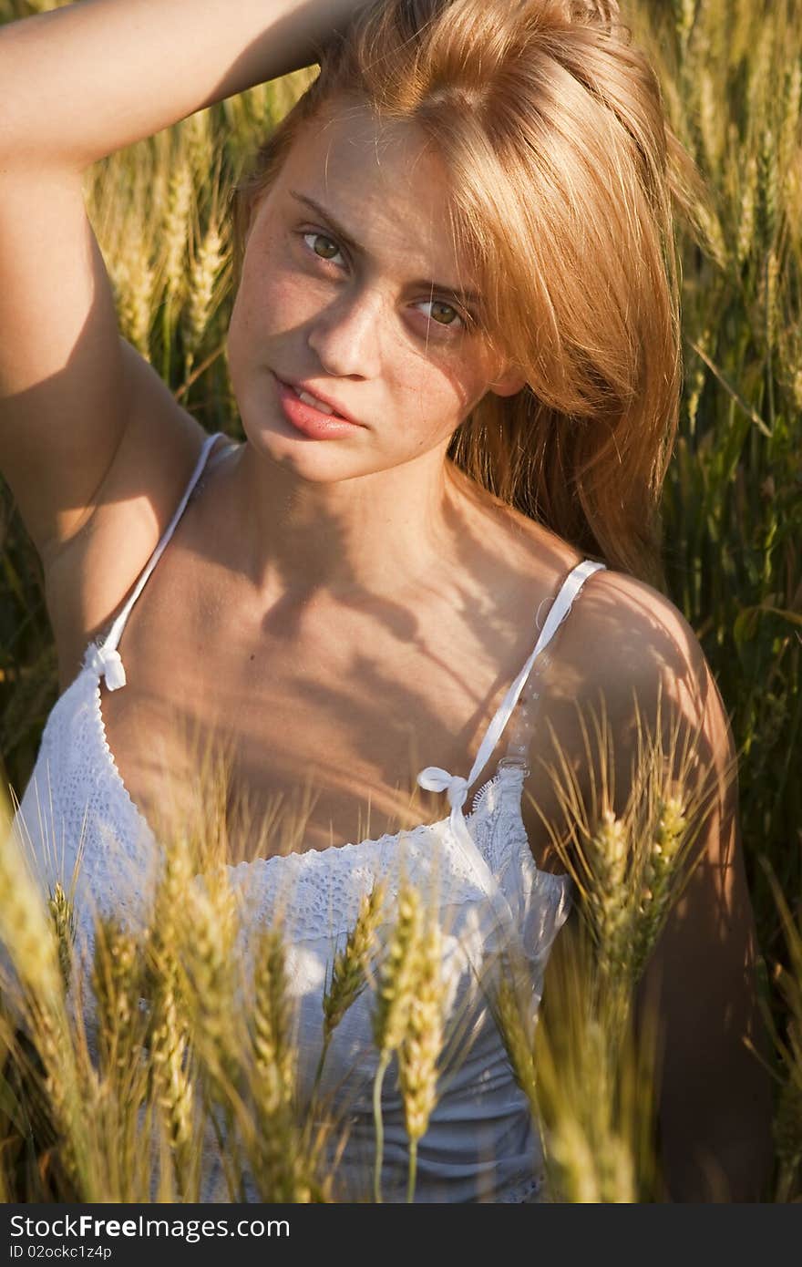 A beautiful woman walks across the field