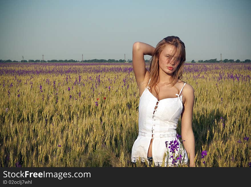 A beautiful woman walks across the field