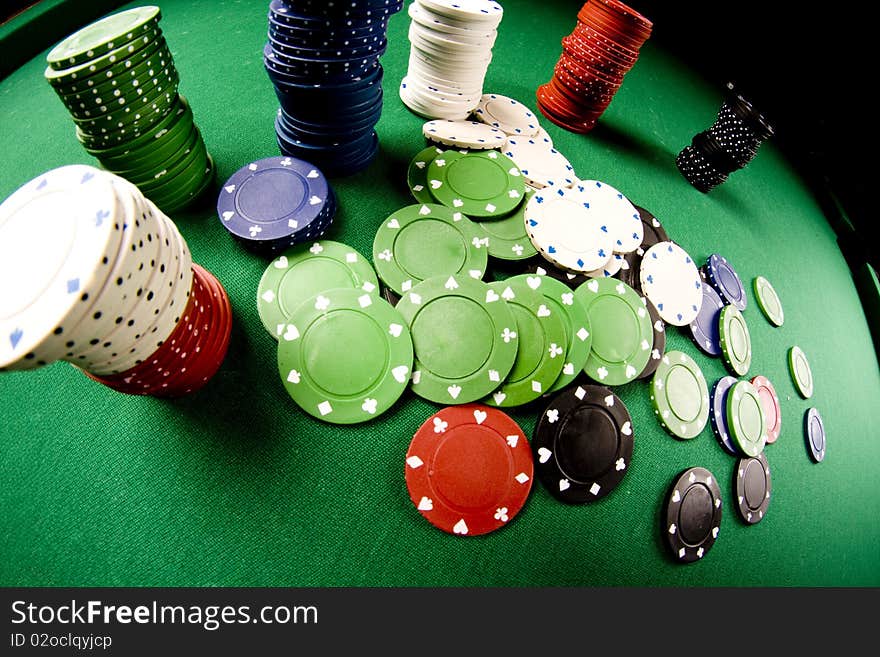 Casino gambling chips on green table. Casino gambling chips on green table