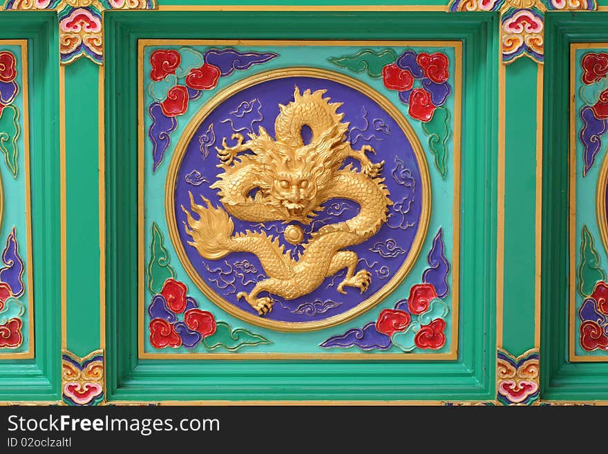 A golden dragon in chinese style. On ceiling.