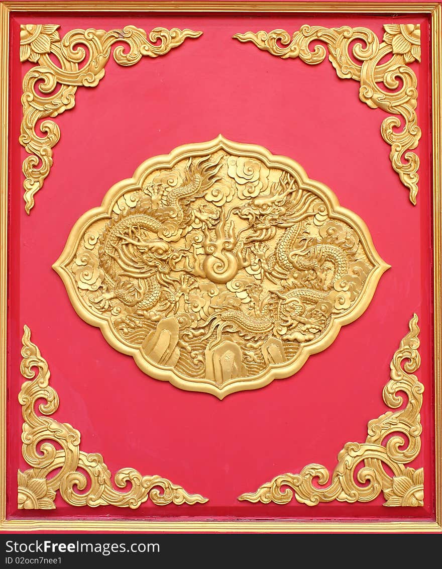 Double golden dragon in chinese style. On red wood.