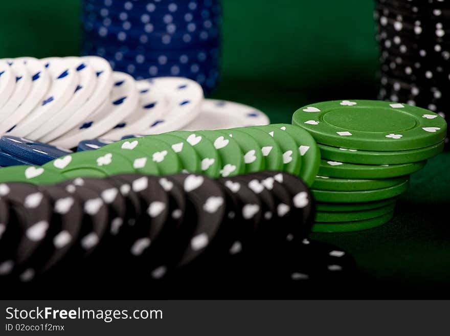 Casino gambling chips on green table. Casino gambling chips on green table