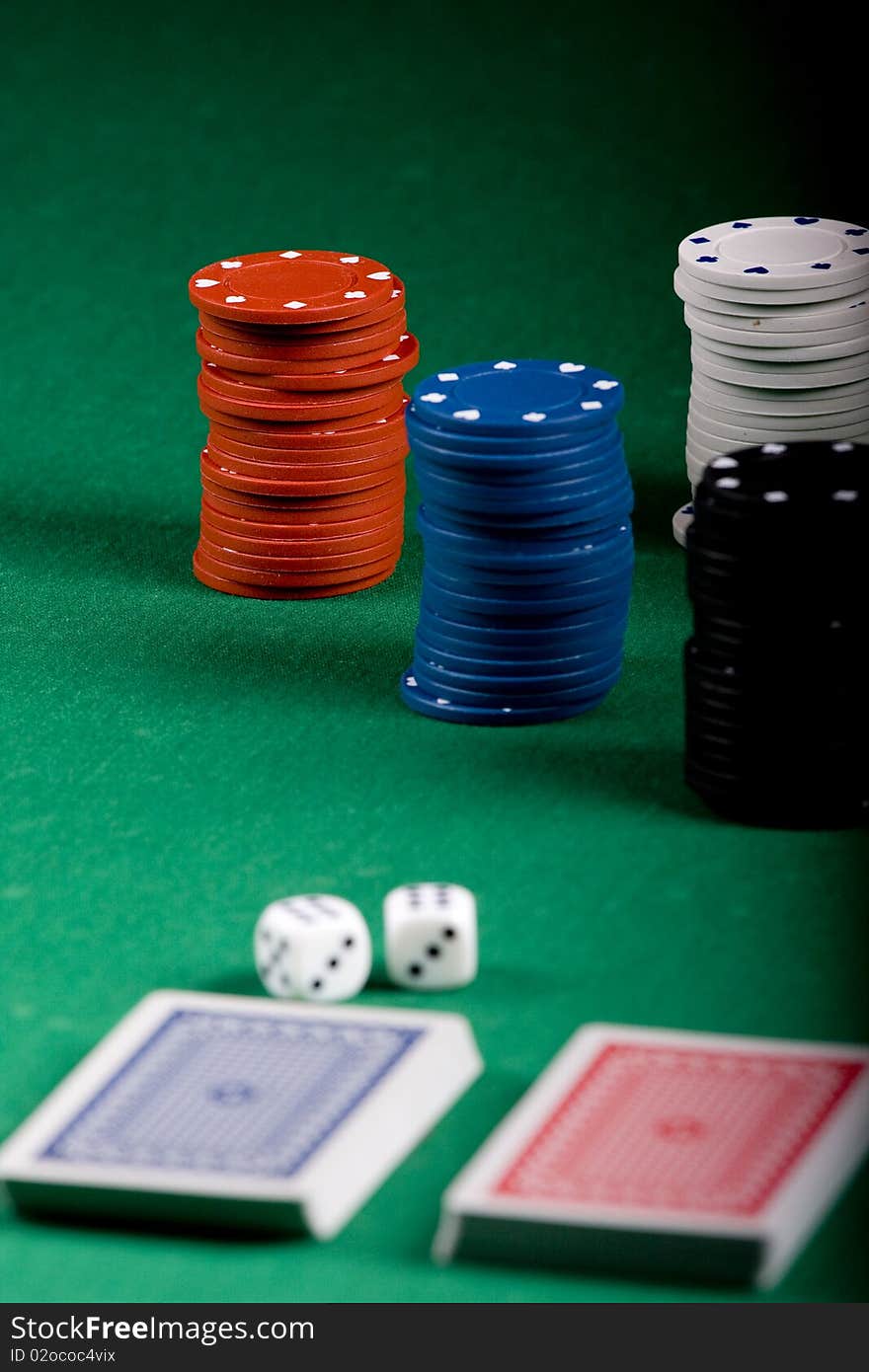 Casino gambling chips on green table. Casino gambling chips on green table