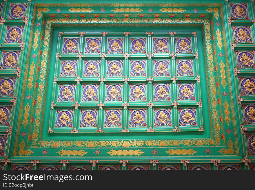 Pattern of golden dragon in chinese style. On ceiling.