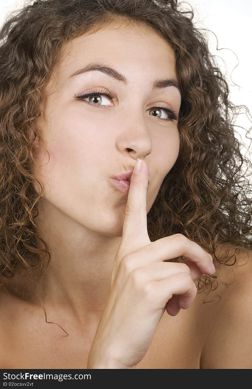 Beautiful woman in silence gesture on white background