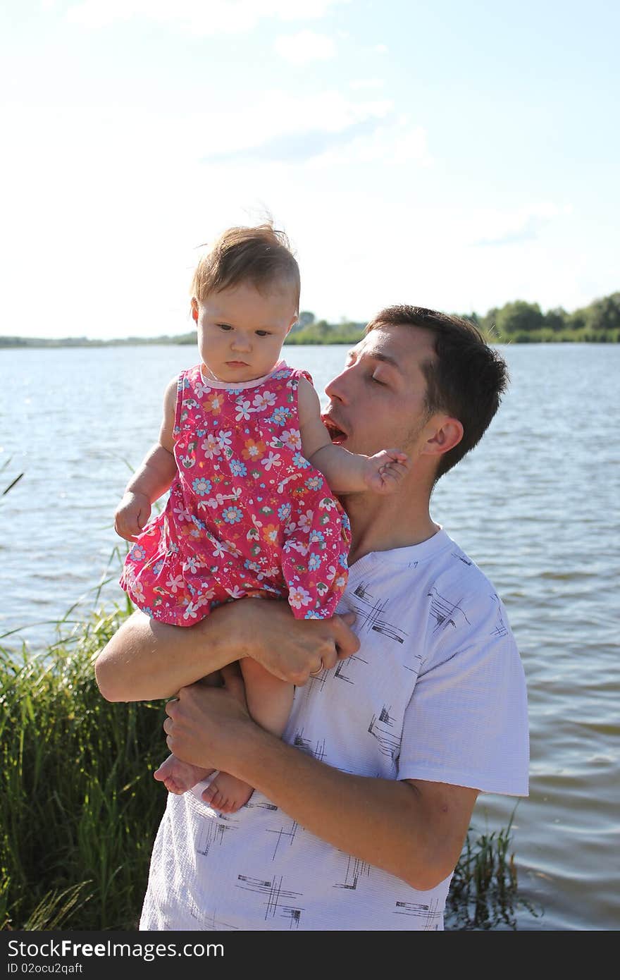 Child with his father at the lake