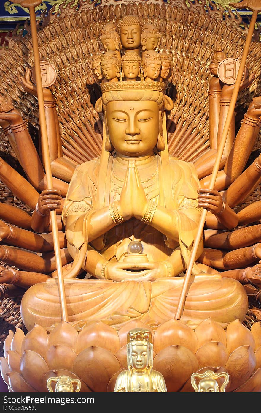 The big kuan has thousand hands. Statue from woods.