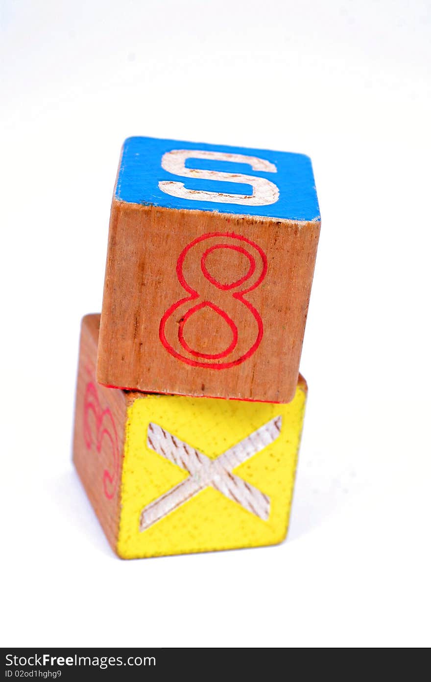 Two childrens wooden blocks showing the number 8 and the letter X. Two childrens wooden blocks showing the number 8 and the letter X