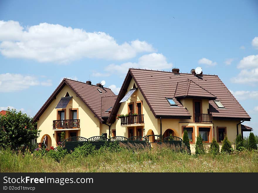 Modern semi-detached house exterior. Sunny weather. Modern semi-detached house exterior. Sunny weather.