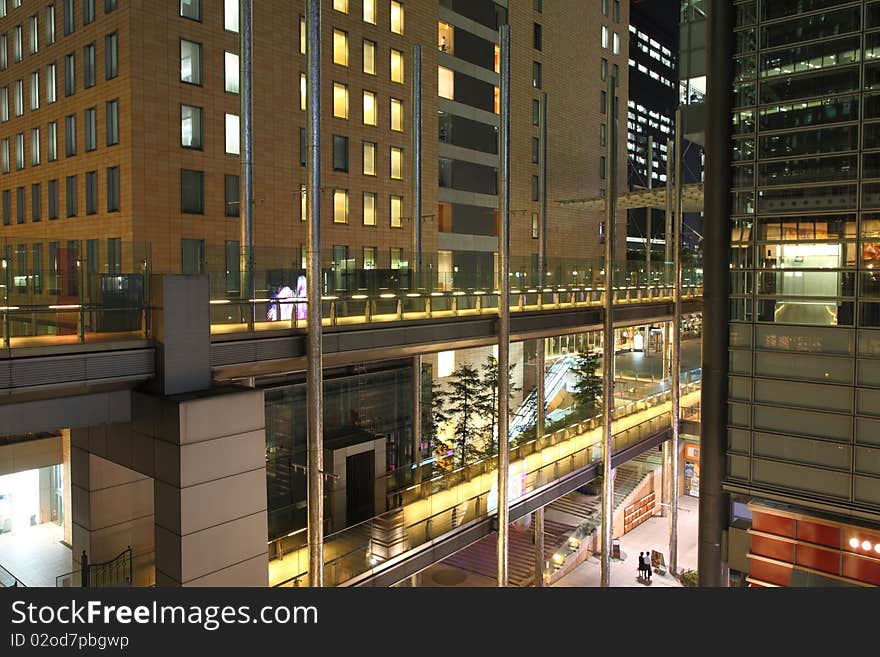 Illuminated footpaths between skyscrapers in Tokyo