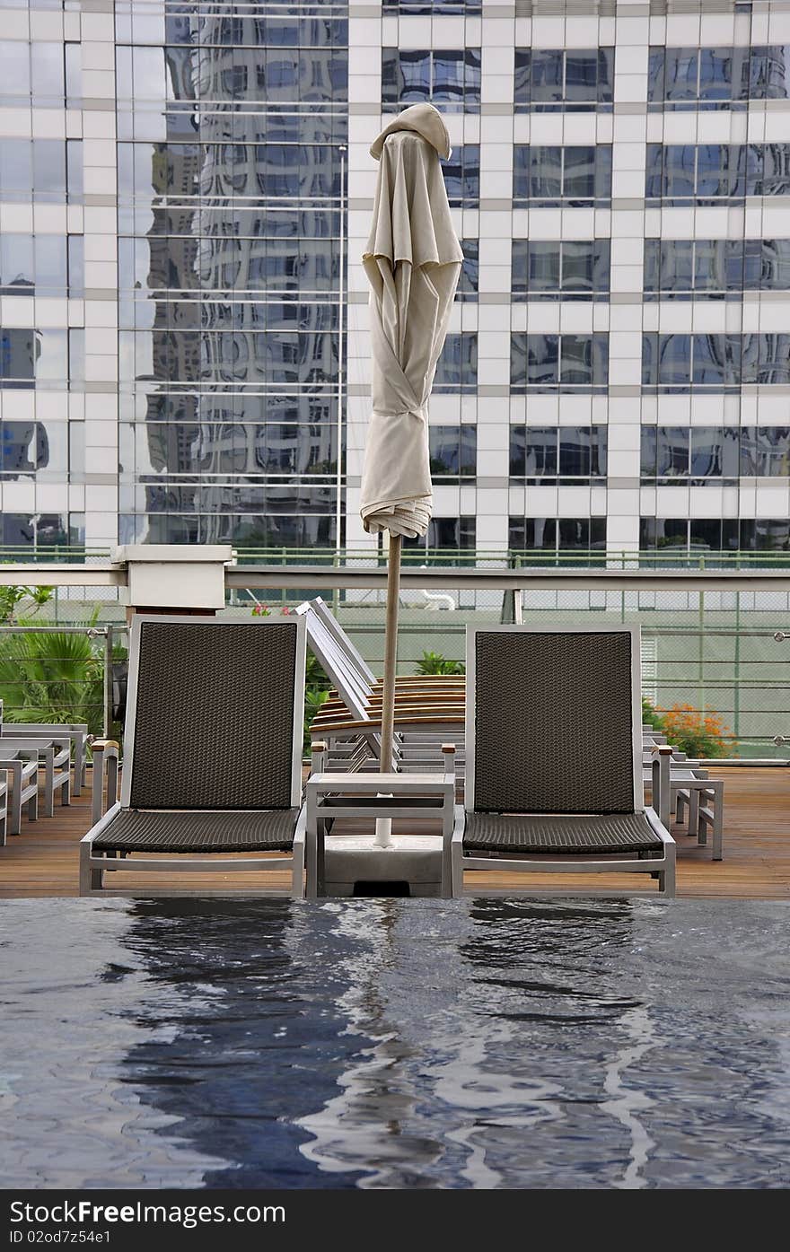 Swimming Chair at swimming pool at the deck of hotel in Thailand