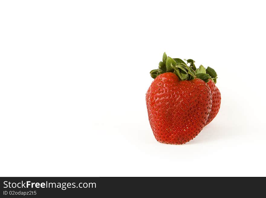 A strawberry isolated on a white background. A strawberry isolated on a white background.