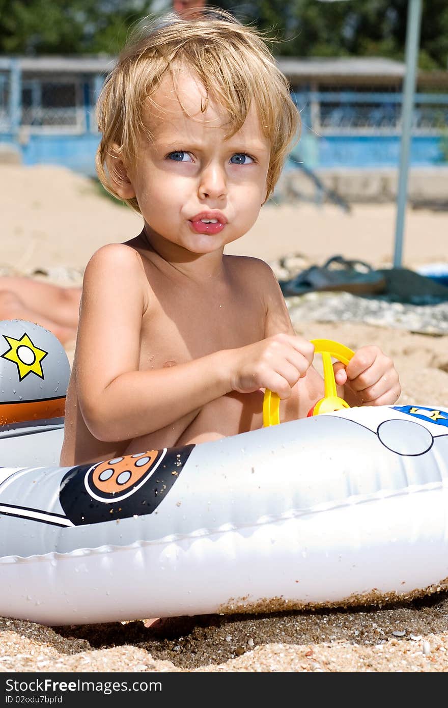 Little boy playing driver at the beach