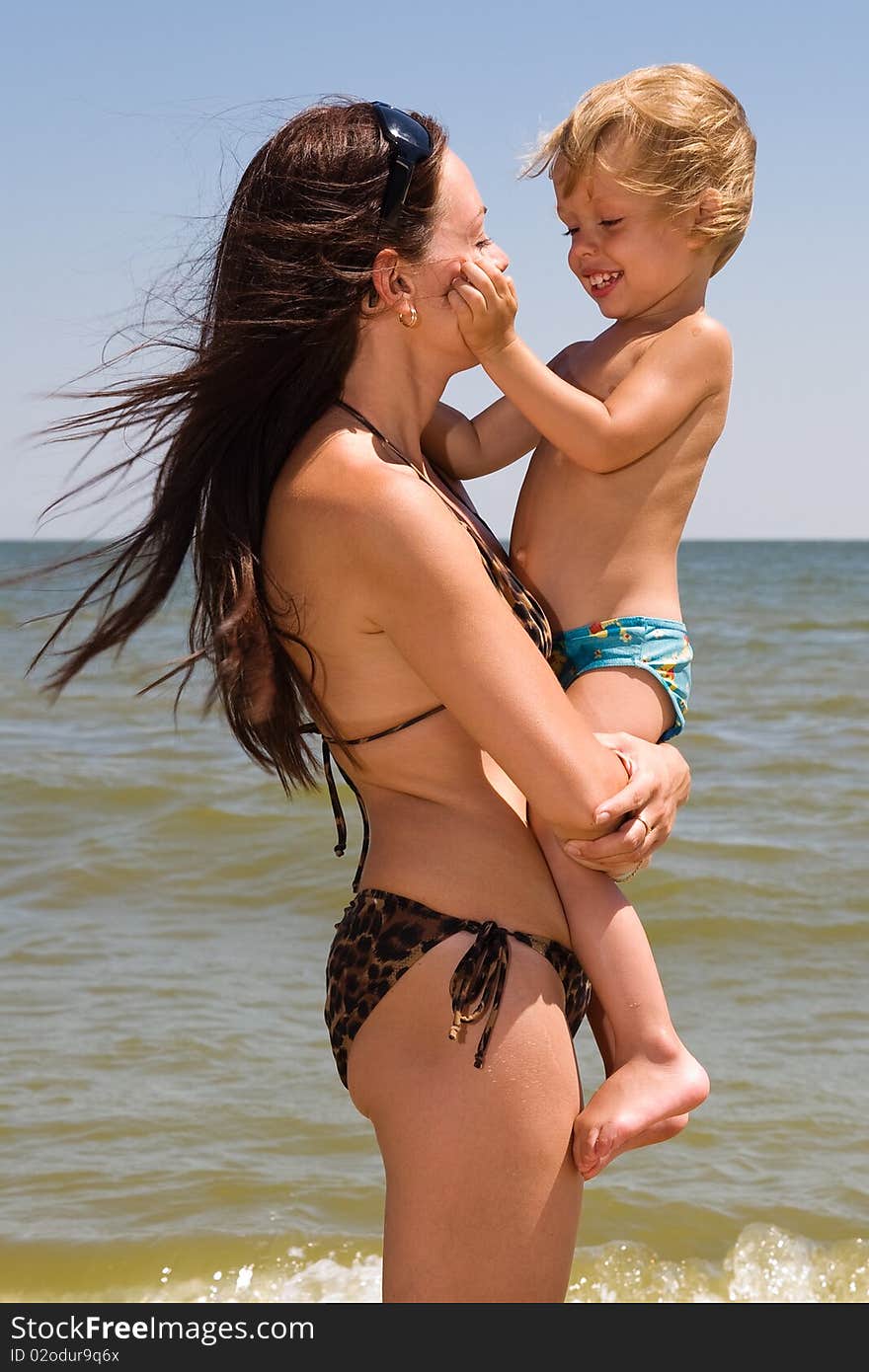 Young Mother Playing With Her Little Son At Sea