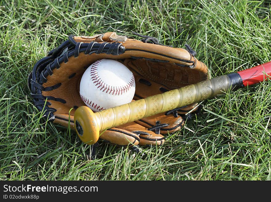 Glove, bat, and ball ready to play the game. Glove, bat, and ball ready to play the game