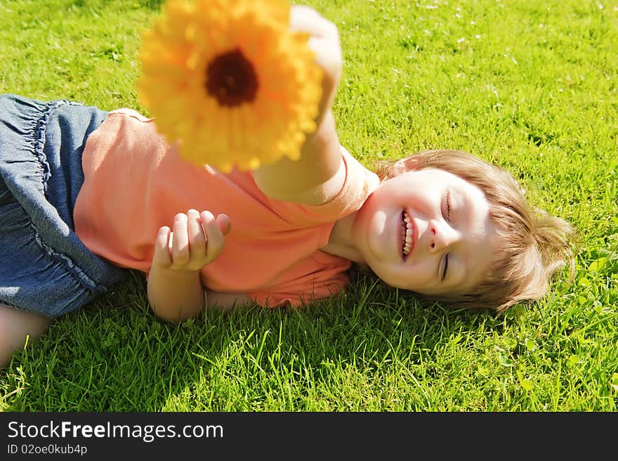 Little girl (3years old) with flower resting on meadow. Little girl (3years old) with flower resting on meadow