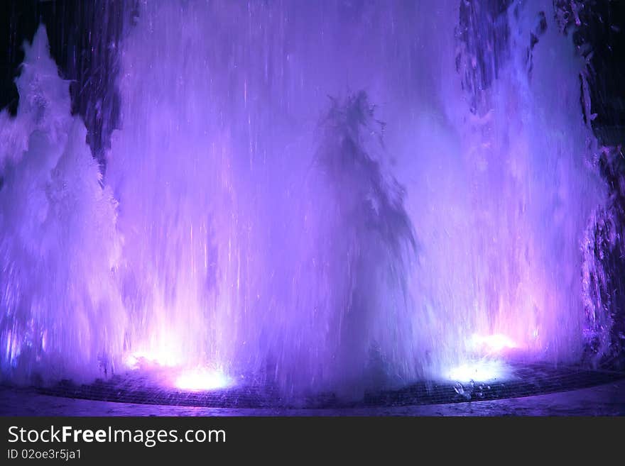 The fountain with colorized light in evening