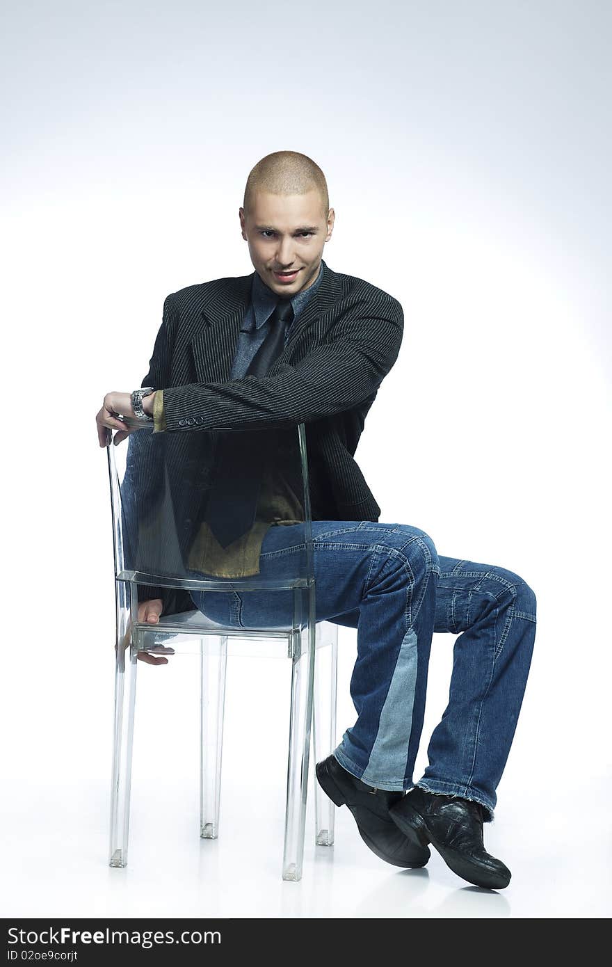 Smiling young male dancer sitting on a chair. Smiling young male dancer sitting on a chair