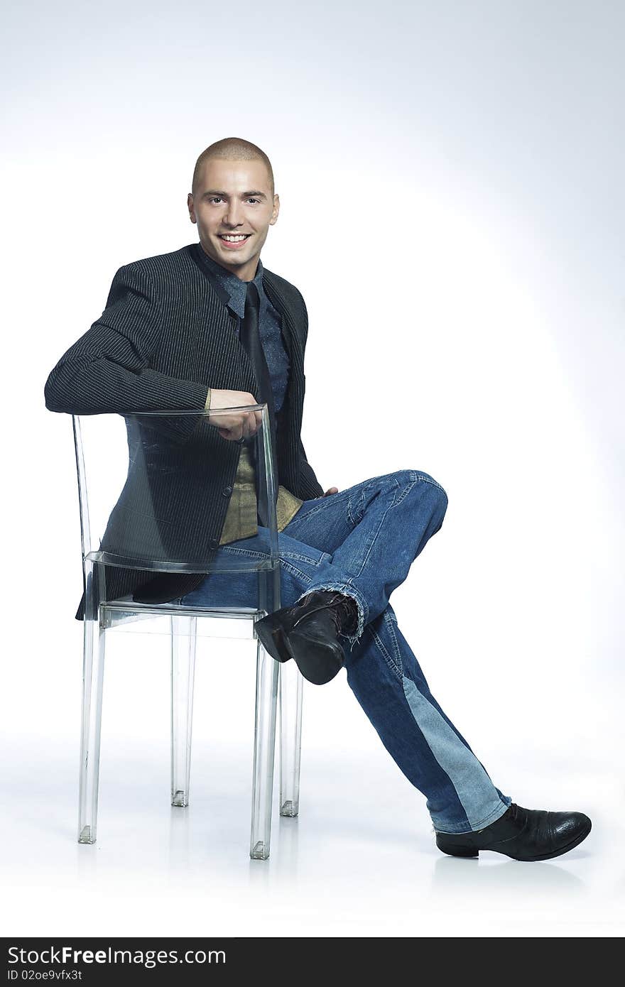 Confident smiling young man sitting in a chair