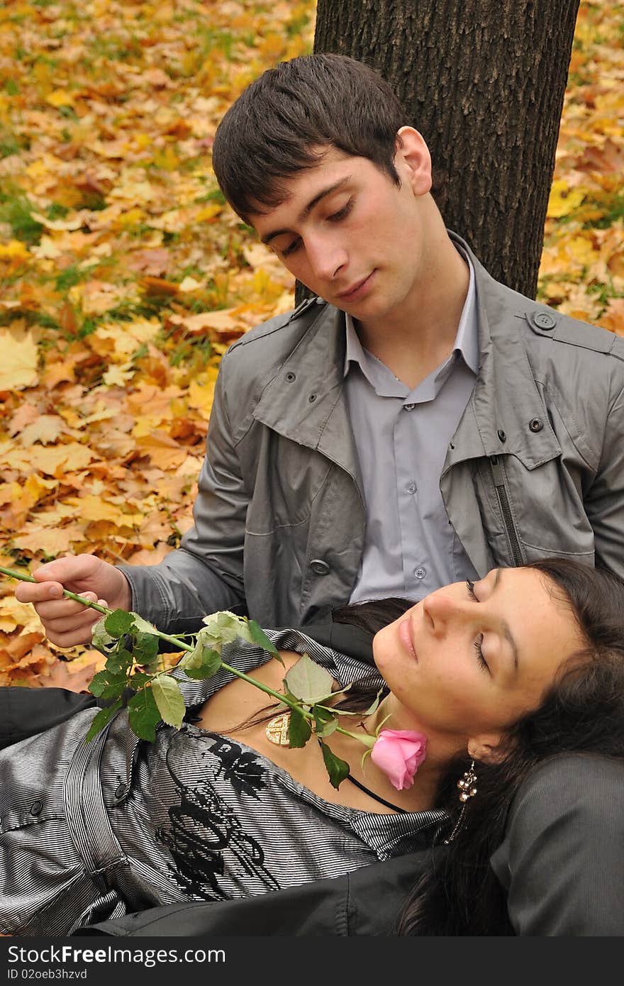 Young falling in love couple drinks tea at the city park. Young falling in love couple drinks tea at the city park