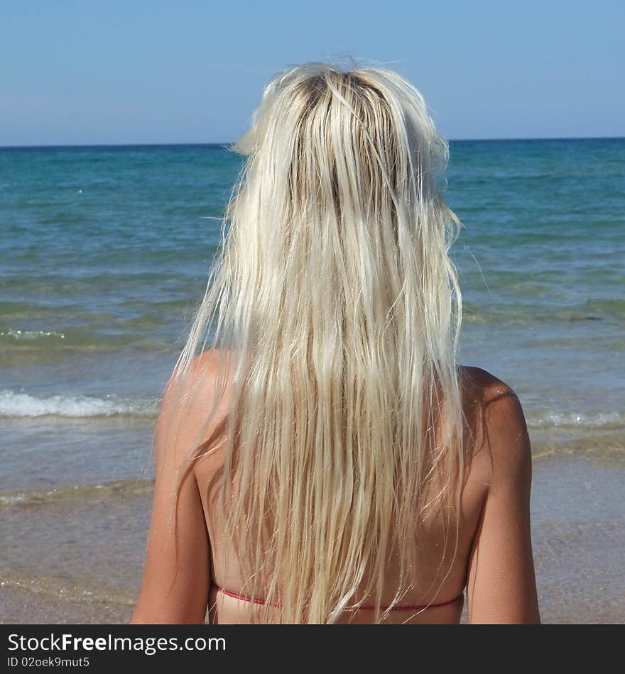 Woman at beach on blue sky