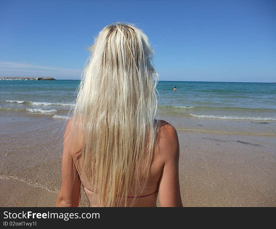 Woman at beach on blue sky