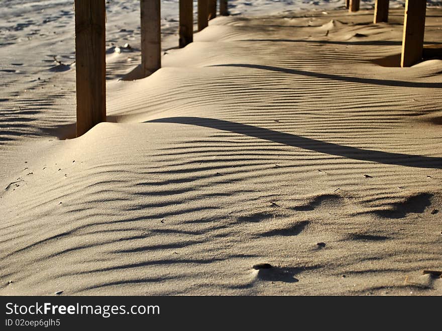 Waves on the sand under a building on a beach. Waves on the sand under a building on a beach