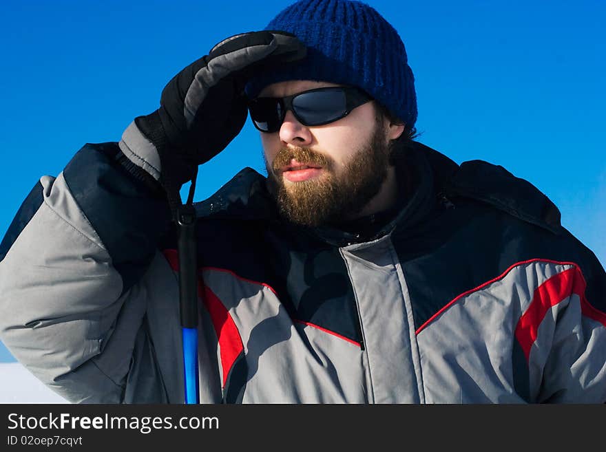 Portrait of handsome skier in the snowy field