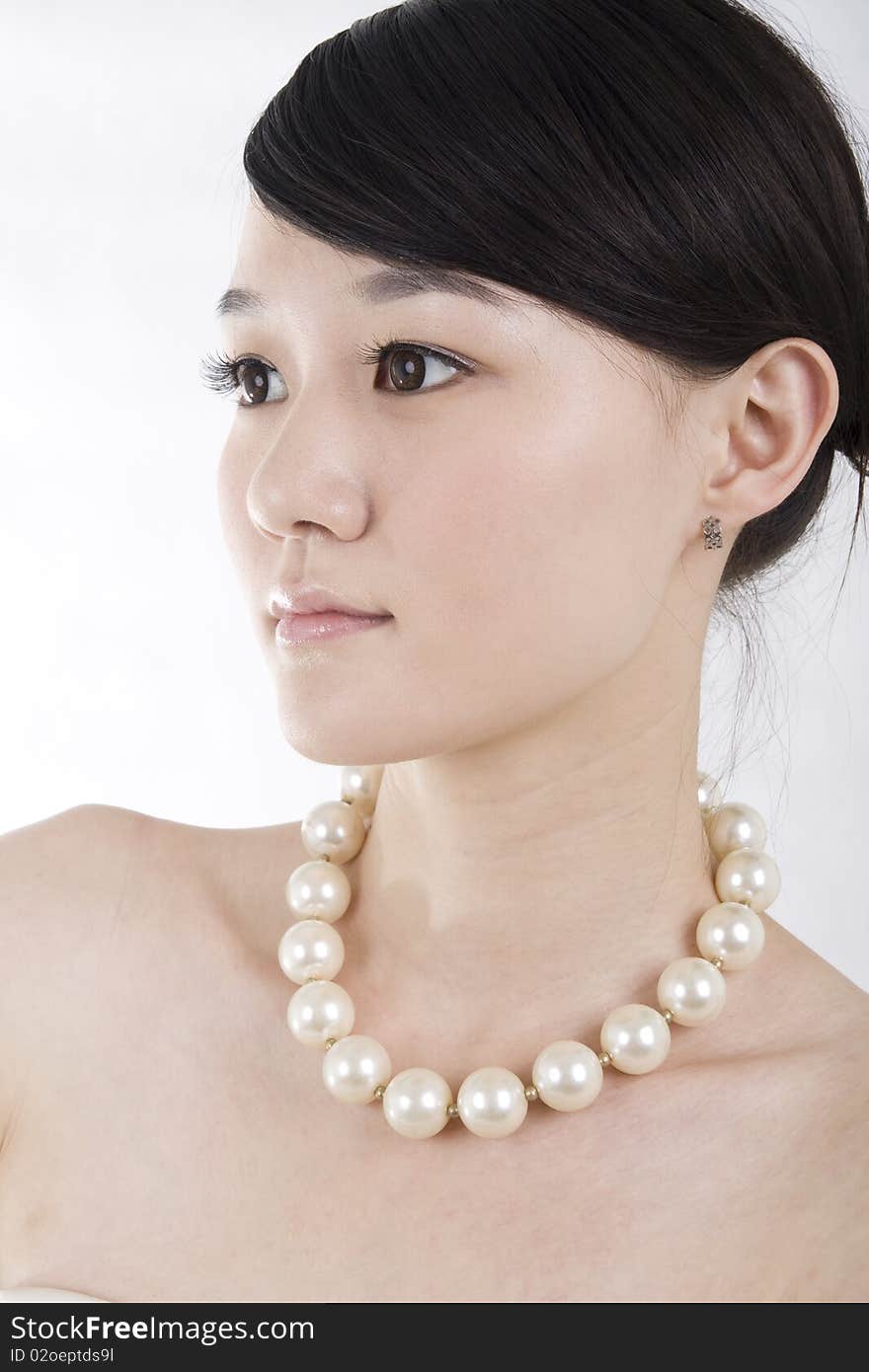 Beautiful bride with perfect natural makeup,wearing pearl necklace