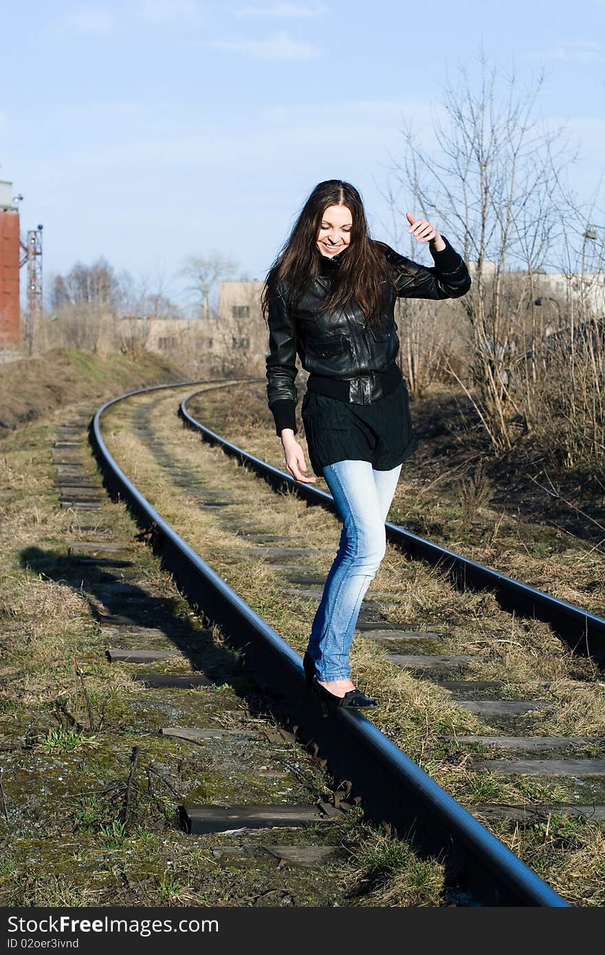 Portrait of a beautiful laughing female model on a railway track. Portrait of a beautiful laughing female model on a railway track