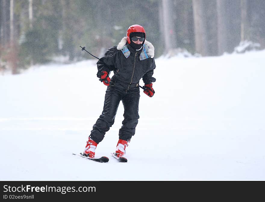 A young woman is skiing at a ski resort. A young woman is skiing at a ski resort