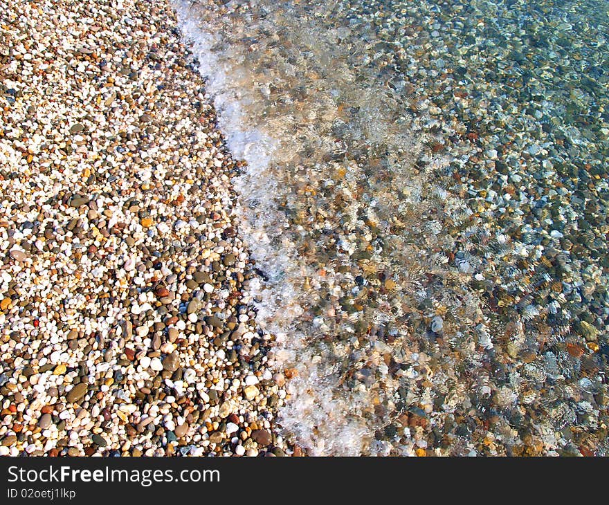 Bright pebble beach and water, Crimea, Ukraine