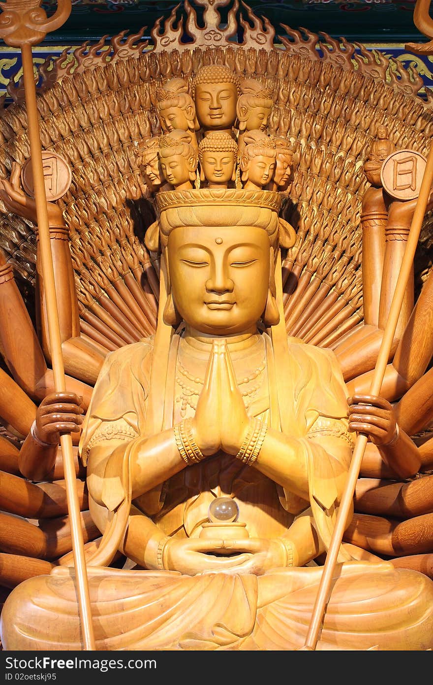 The big kuan has thousand hands. Statue from woods.