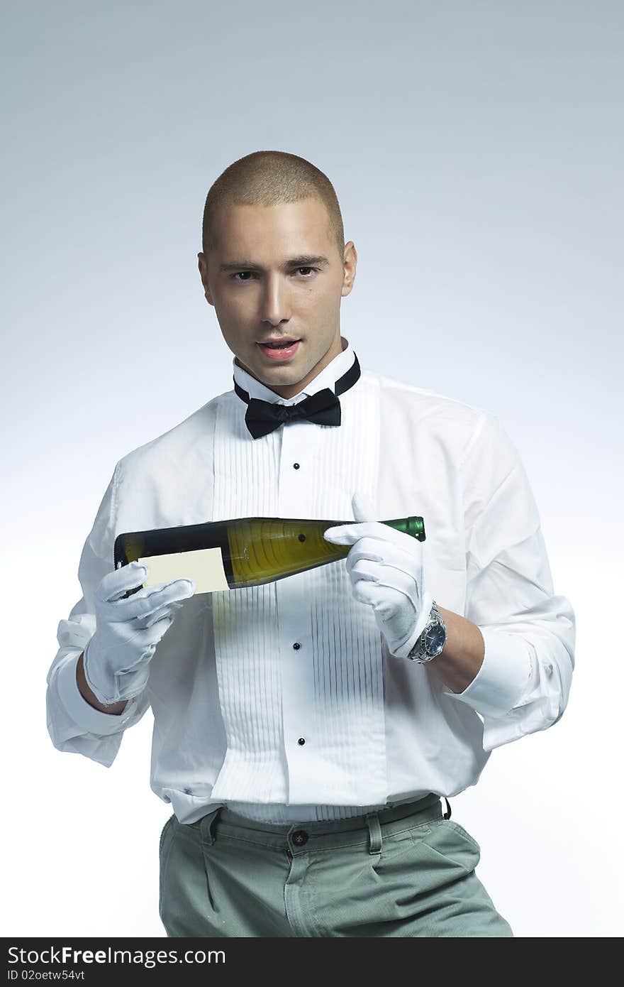 Cool wine waiter holding a bottle of white wine. Cool wine waiter holding a bottle of white wine