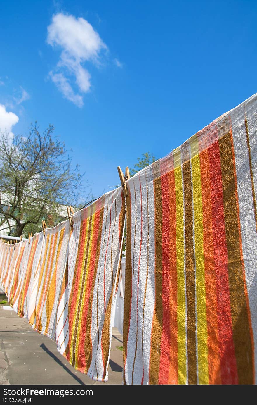 Photo of towels that hang on the rope against the sky