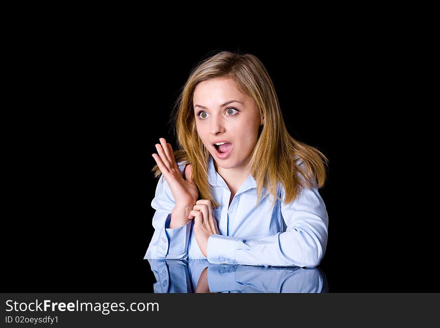 Young attractive businesswoman, surprised by something, studio shoot isolated on black background. Young attractive businesswoman, surprised by something, studio shoot isolated on black background