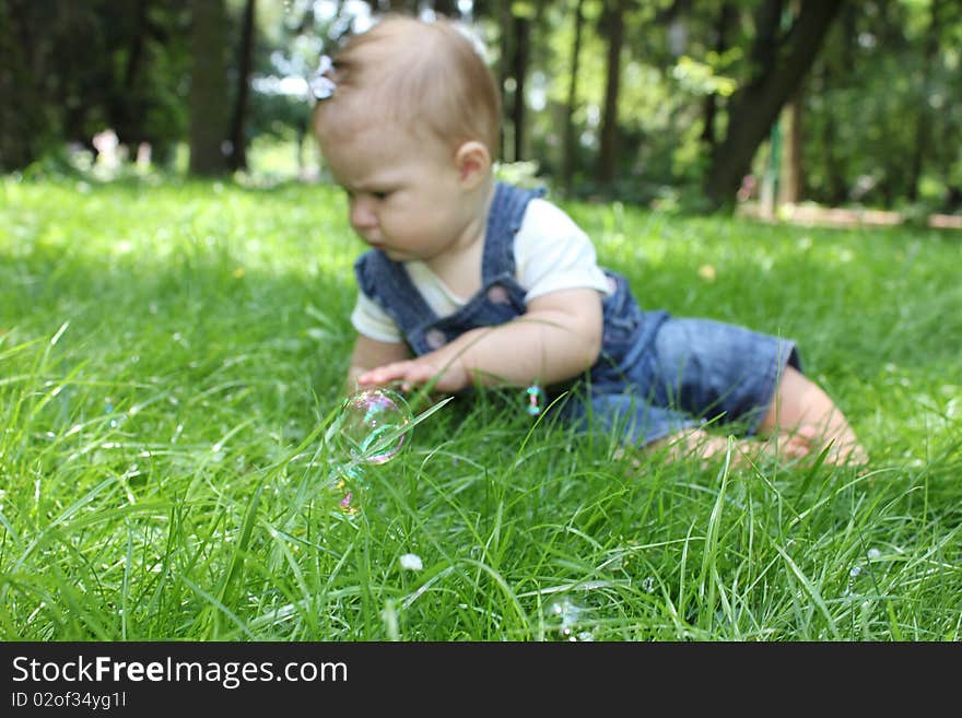 Little girl on the green grass