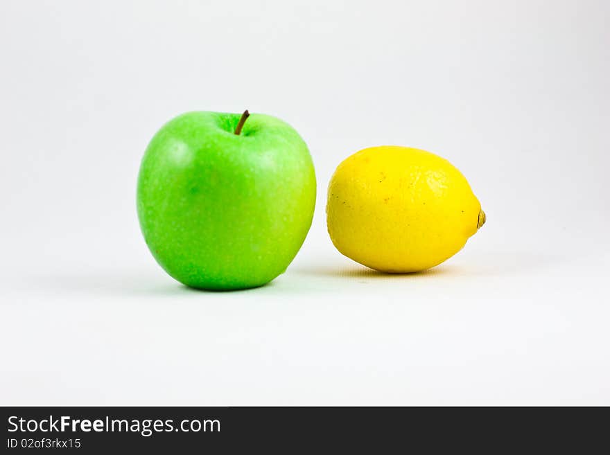 A fresh apple and lemon showing together. A fresh apple and lemon showing together