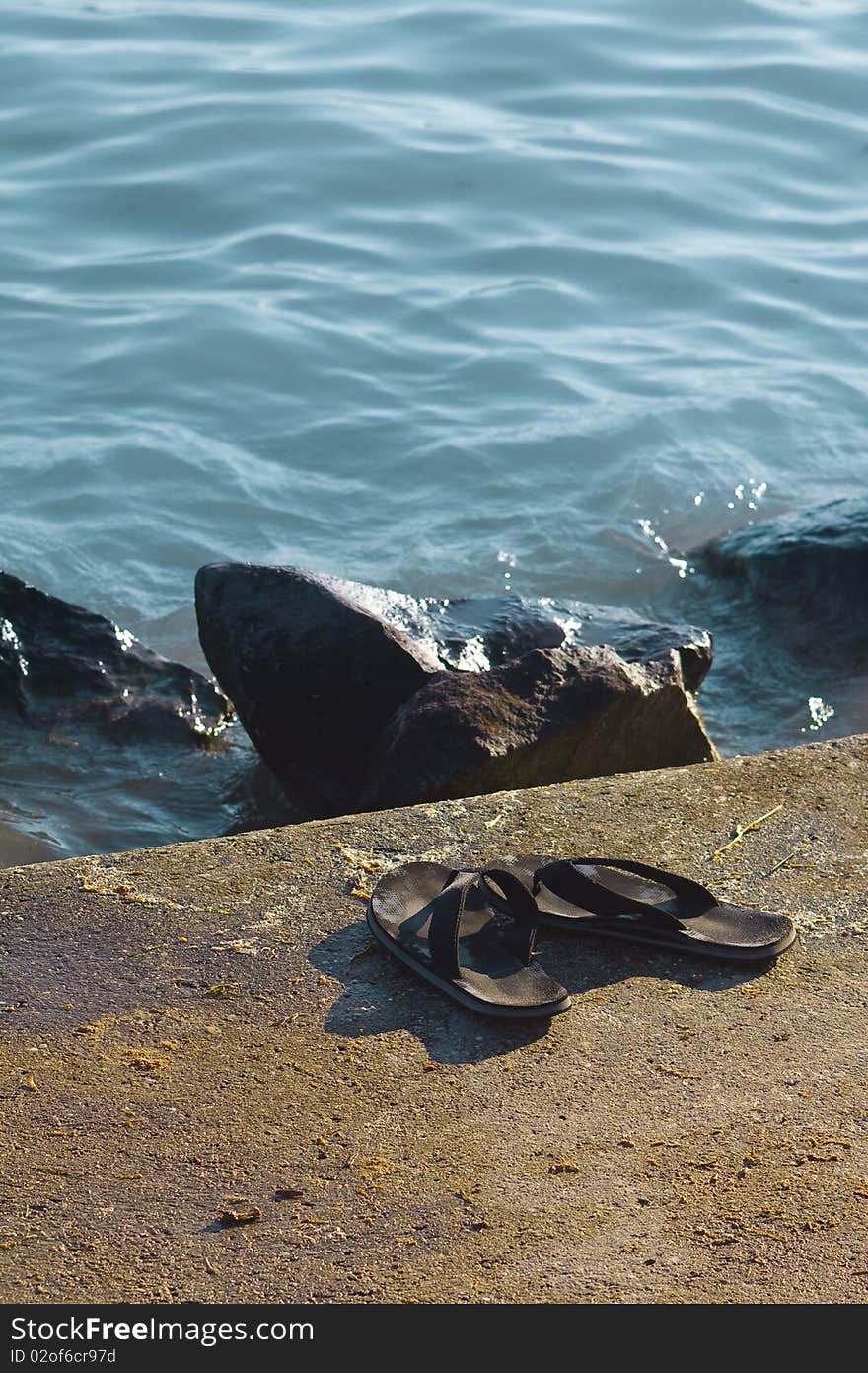 A pair of slippers on the beach. A pair of slippers on the beach