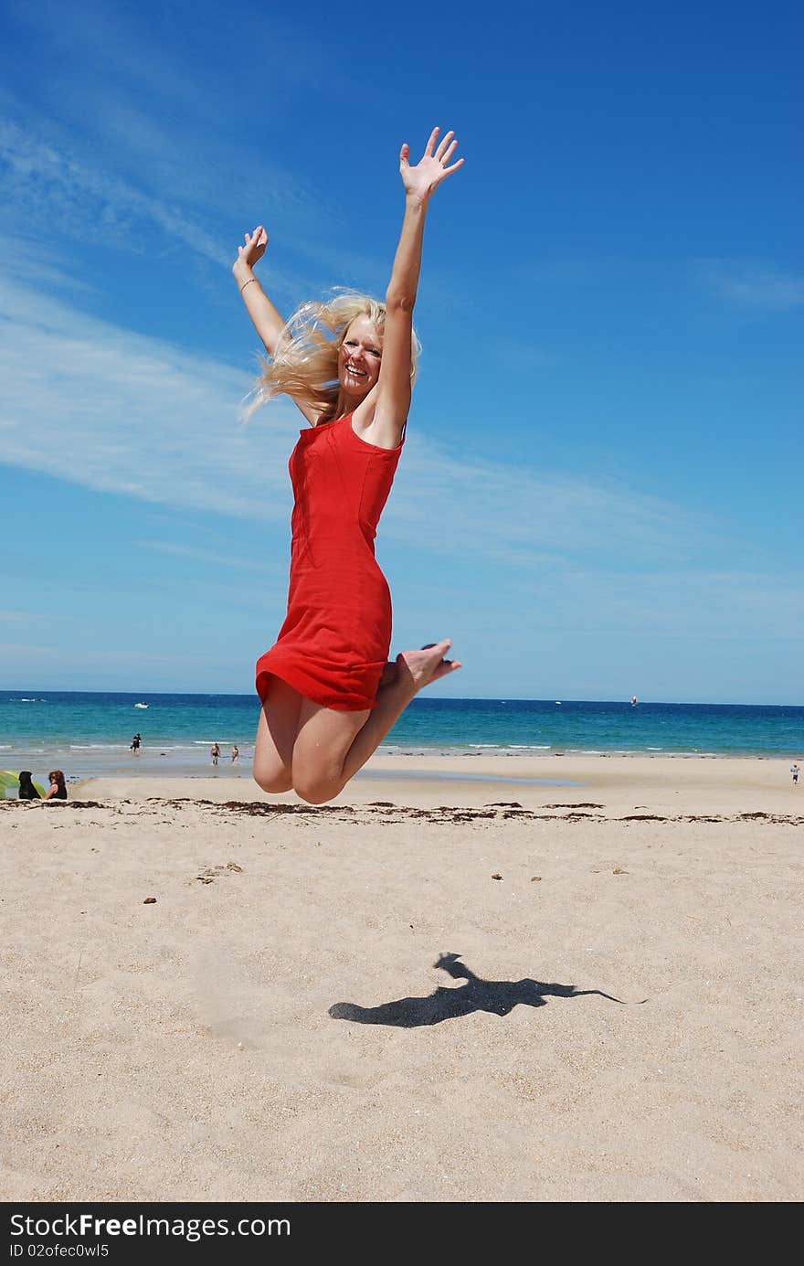 Woman Jumping on beach in Brittany