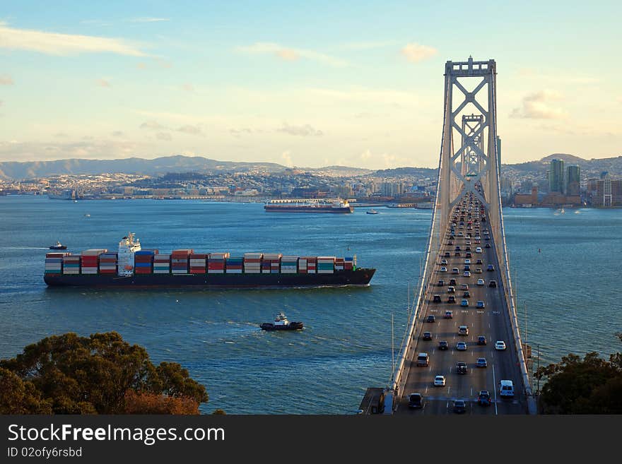 Freight ship passing under Bay Bridge, San Francisco Bay. Freight ship passing under Bay Bridge, San Francisco Bay.