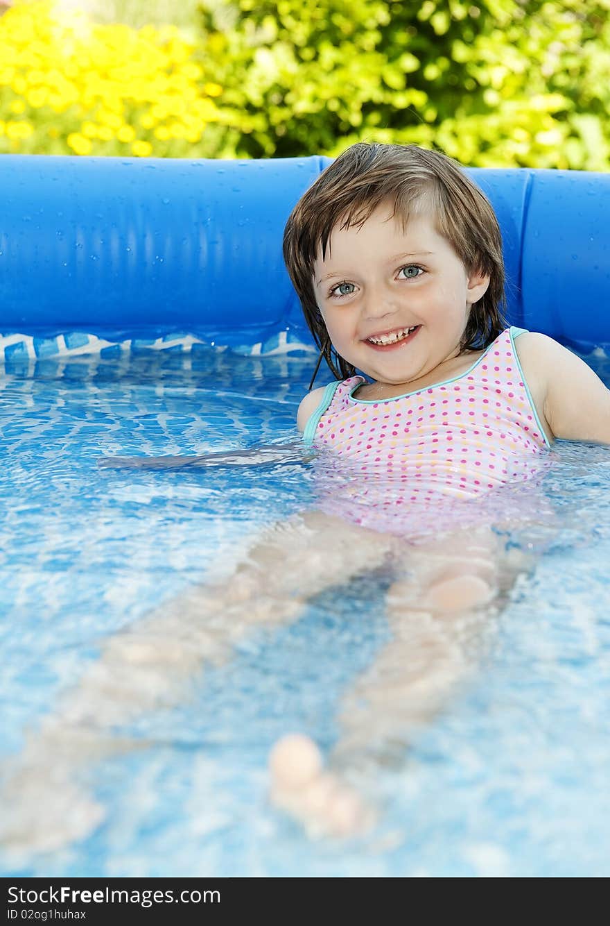 little girl swimming in basin