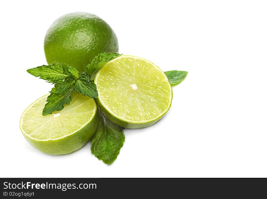 Green limes with mint isolated on white