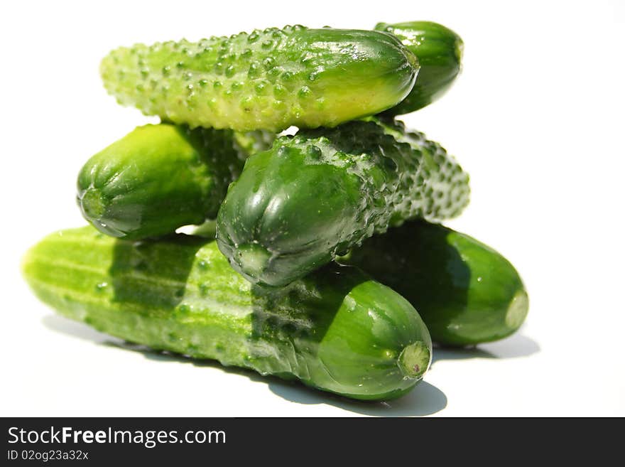 Pile made with six green cucumbers isolated on a white. Pile made with six green cucumbers isolated on a white