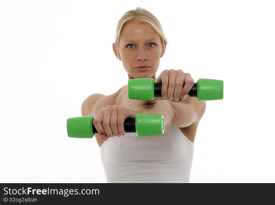 Portrait of a young caucasian woman who trains with dumbbells in hand