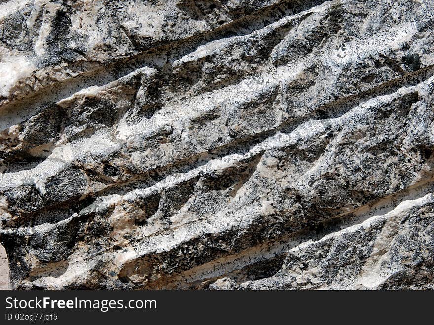 Rocky surface including stripes, ideal as a background or texture. Rocky surface including stripes, ideal as a background or texture.