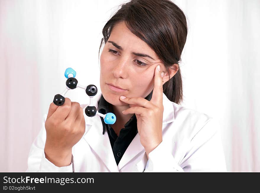 Female scientist in a laboratory working with an organic molecule. Female scientist in a laboratory working with an organic molecule